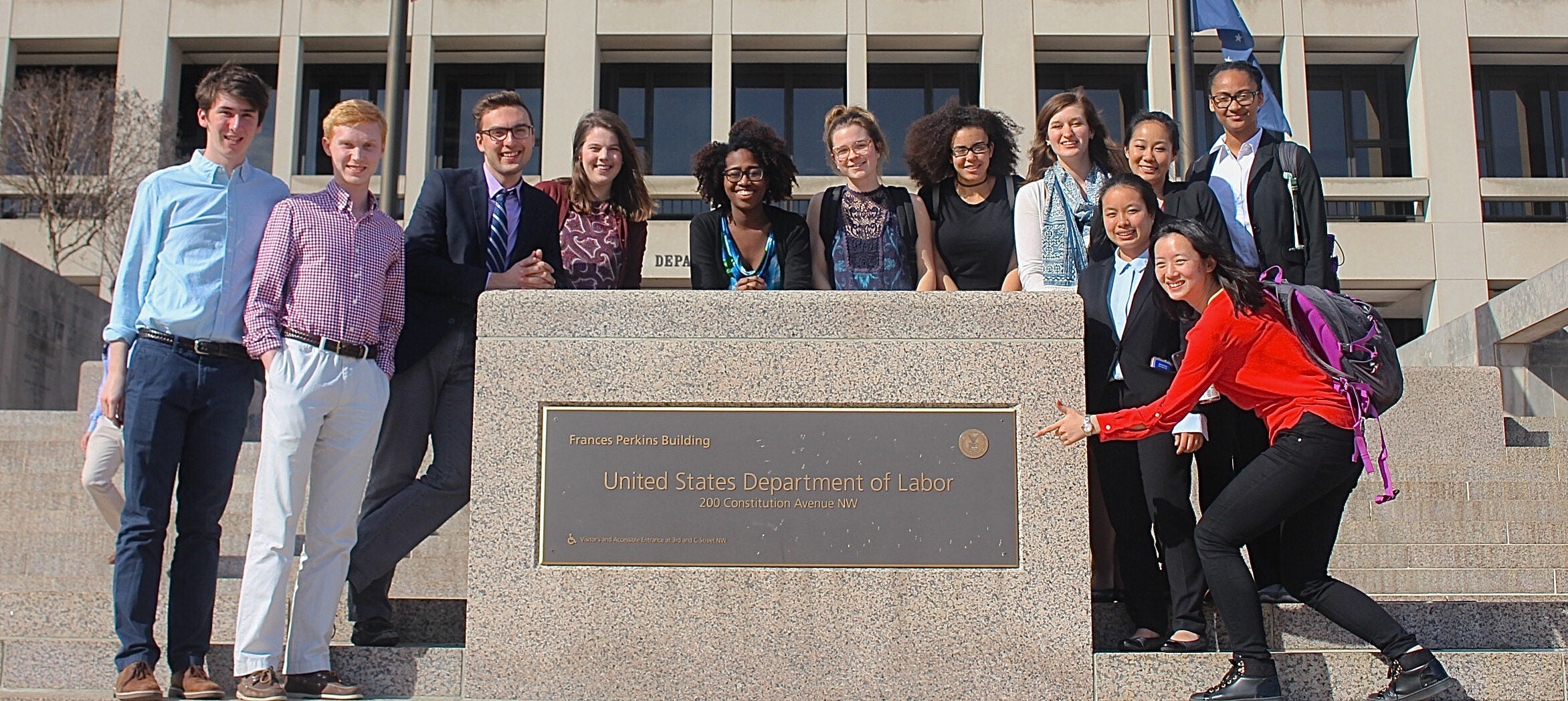 Student participants in the Worker's Justice DC Alternative Breaks trip in front of the US Department of Labor building.