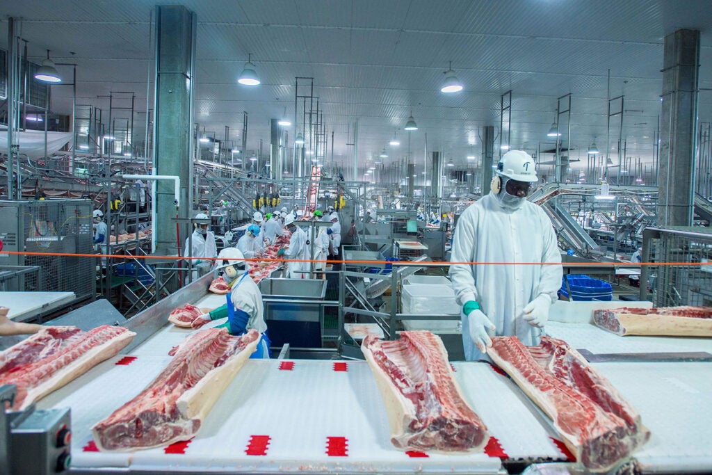 Meatpackers on a factory line