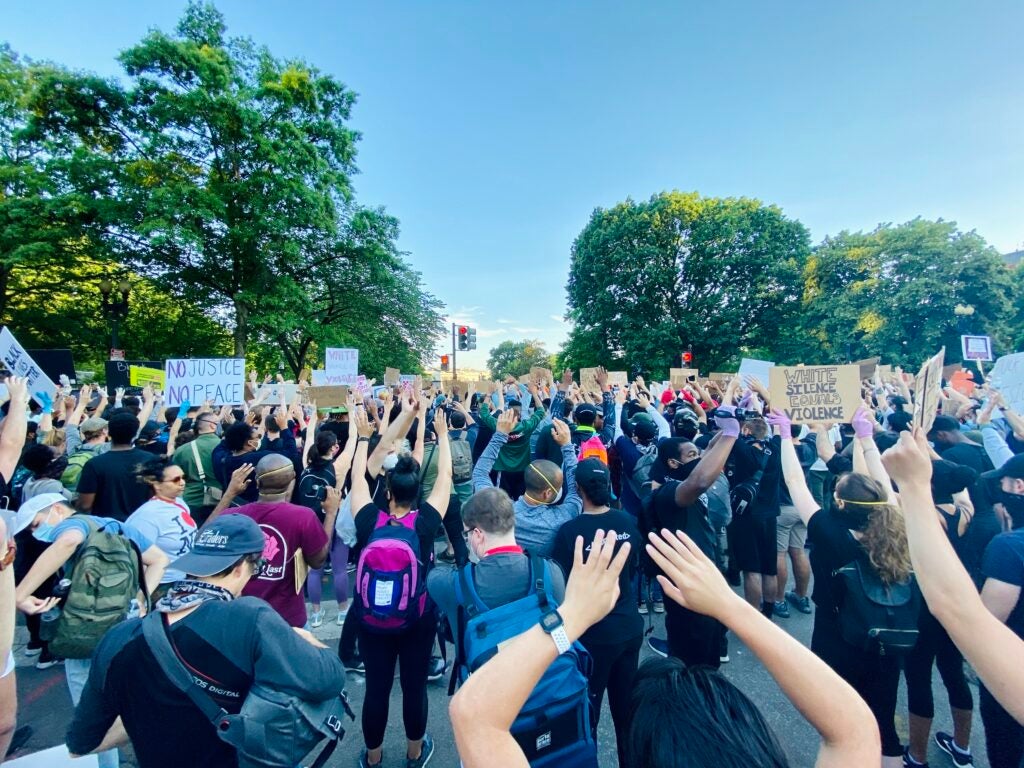 Protesters holding signs with messages like 