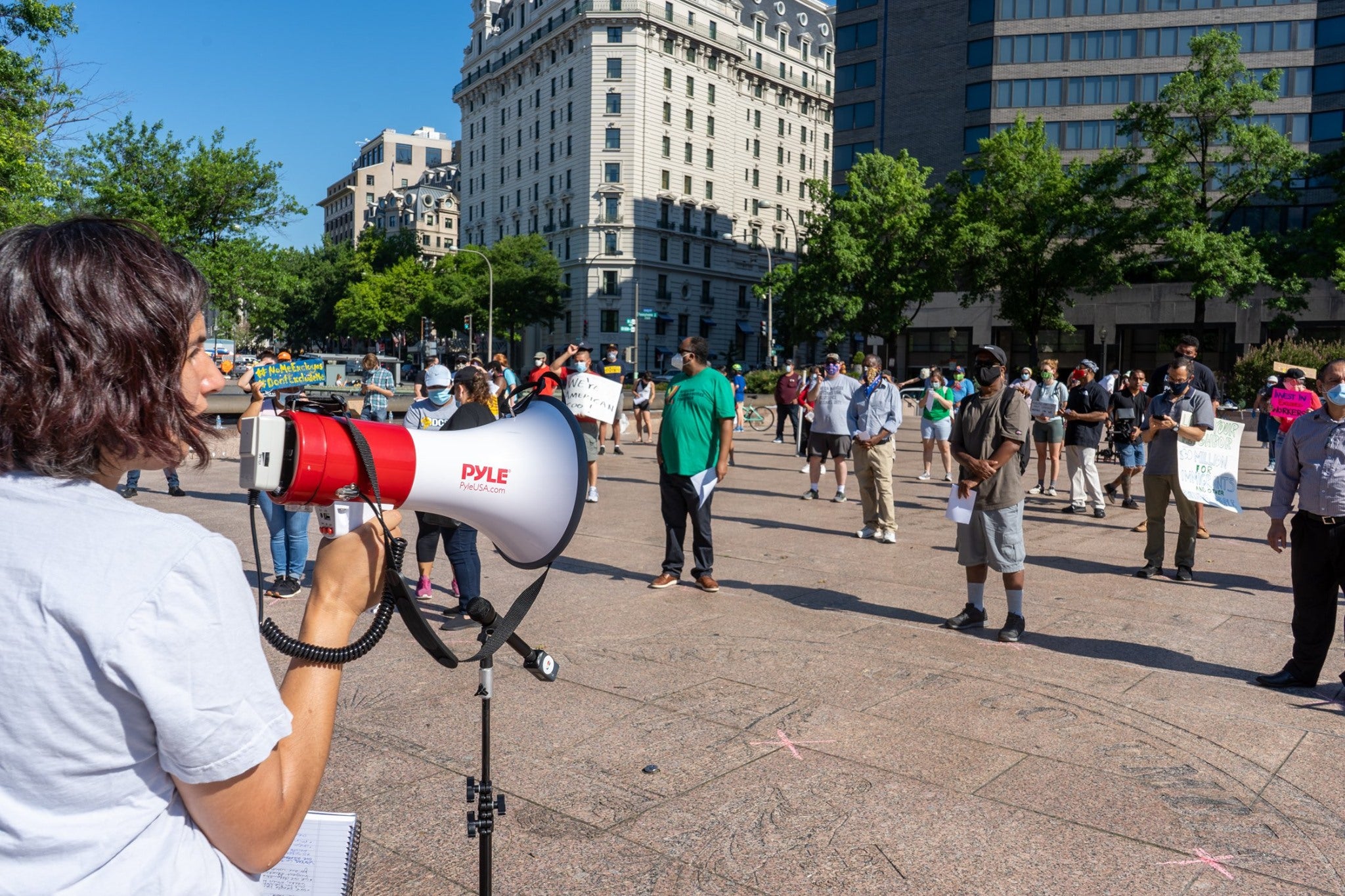 Person speaks into a megaphone at a protest.
