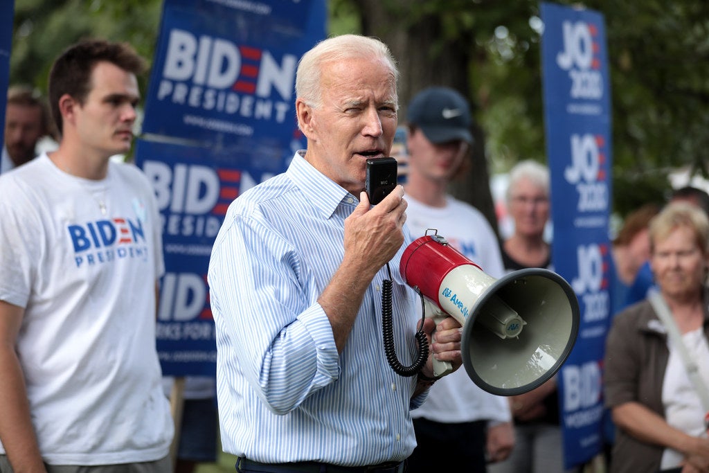 Joe Biden speaking into a megaphone at a campaign rally.