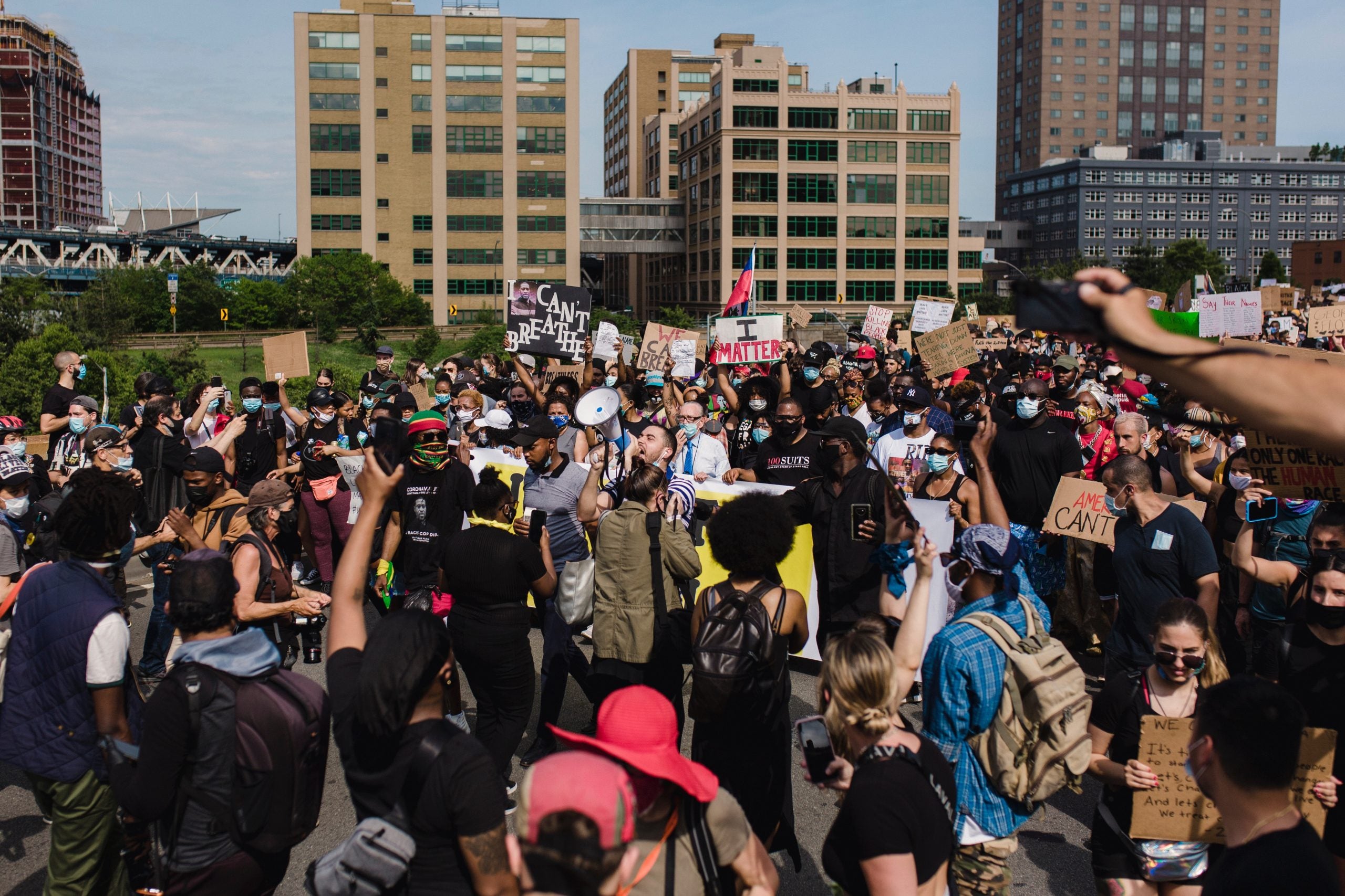 Protesters holding signs with phrases like 